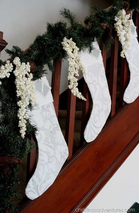 White stockings on the staircase with garland