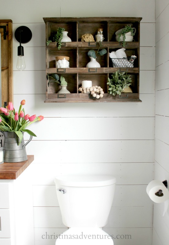 wood cubby over the toilet with shiplap wall
