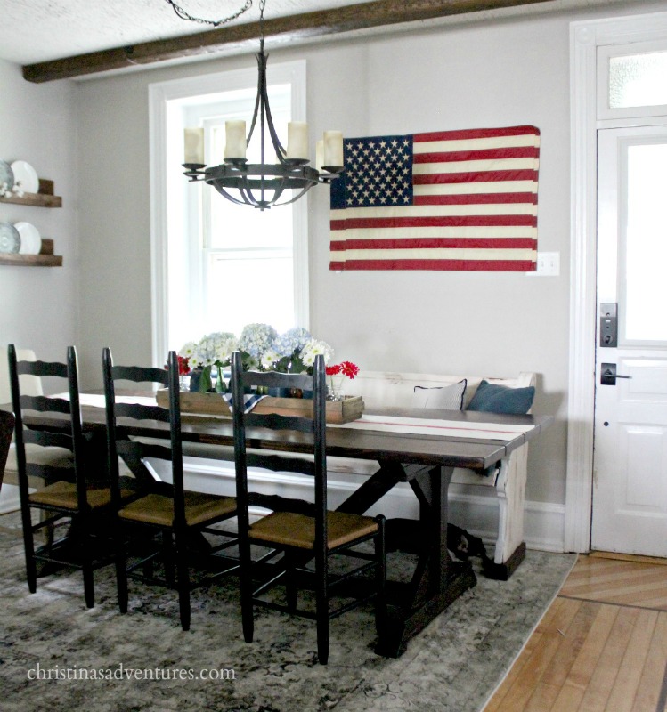 This simple 4th of July table combines a casual vintage feel with mason jars, an antique box, vintage flag and fresh flowers