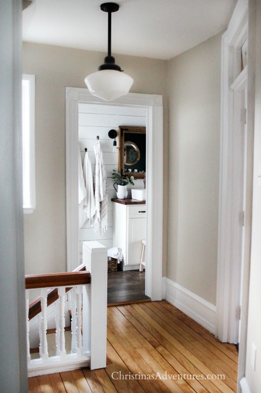 neutral hallway with wood tones and old house trim