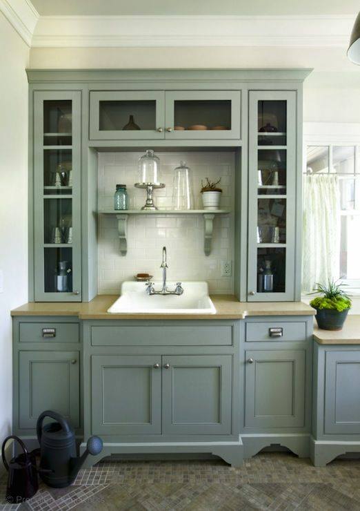 sage green cabinets for a butlers pantry with white sink and clear glass