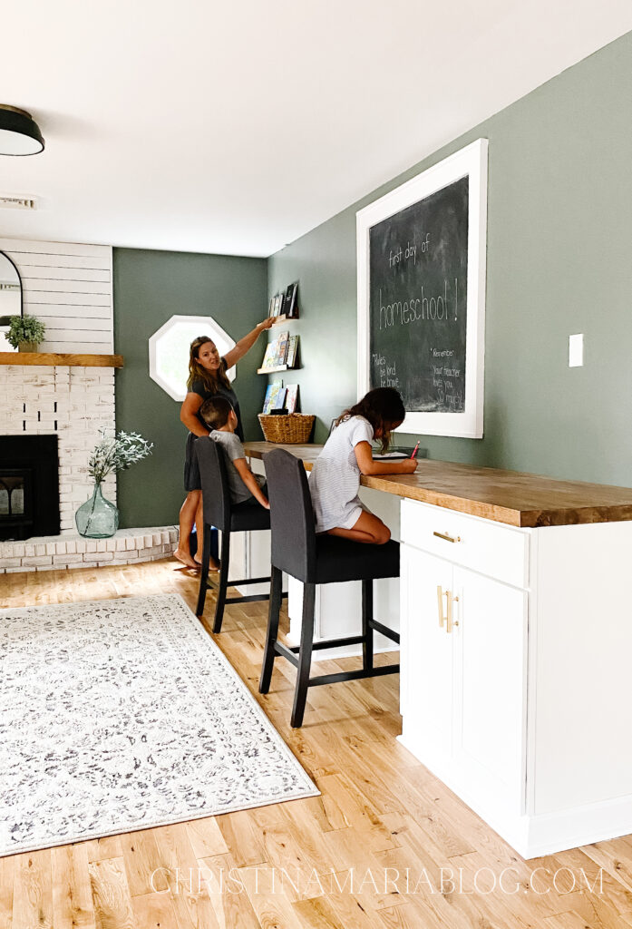 simple beautiful homeschool room with built in desk butcher block top white cabinets