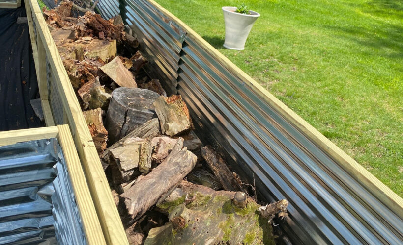 raised garden bed with wood on the bottom