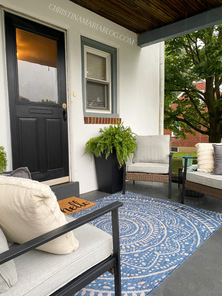 back porch reveal with blue rug