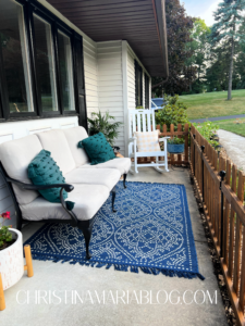 concrete front porch with picket fence