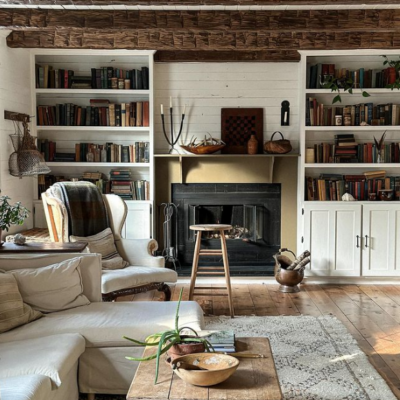 fireplace with wood beams on ceiling and built in bookcases